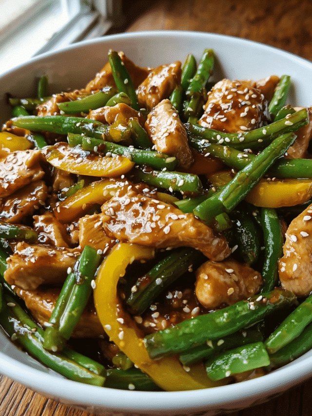 Honey sesame chicken stir fry in skillet with vegetables
