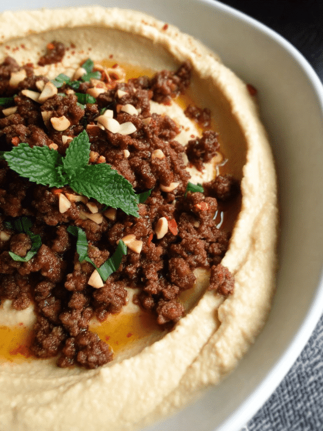 Savory spiced beef over creamy hummus with toasted pine nuts and pita bread