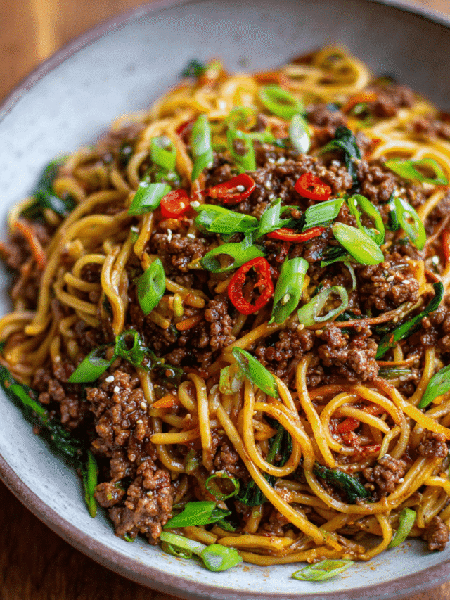 Bowl of sticky beef noodles with scallions