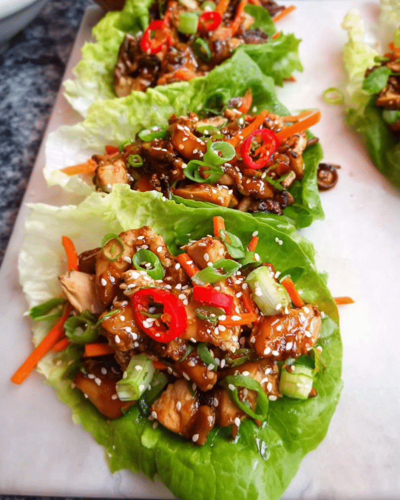 Asian chicken lettuce wraps served with vegetables