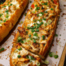 Buffalo chicken stuffed garlic bread on a cutting board