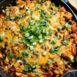 Cheesy chicken enchilada rice skillet in a pan