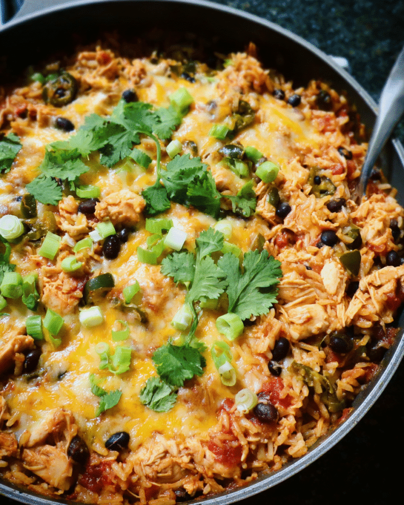 Cheesy chicken enchilada rice skillet in a pan