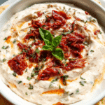 Creamy Sun-Dried Tomato Dip served with fresh vegetables and bread