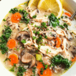 Bowl of creamy chicken and orzo soup with parsley and parmesan