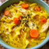 Turmeric chicken noodle soup in a bowl