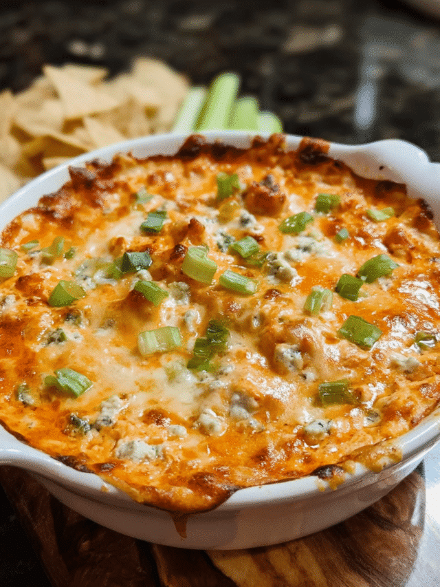 Buffalo chicken dip in a baking dish with melted cheese
