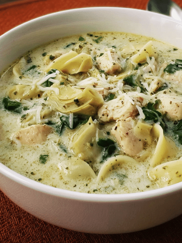 Bowl of creamy pesto chicken soup with spinach and pasta
