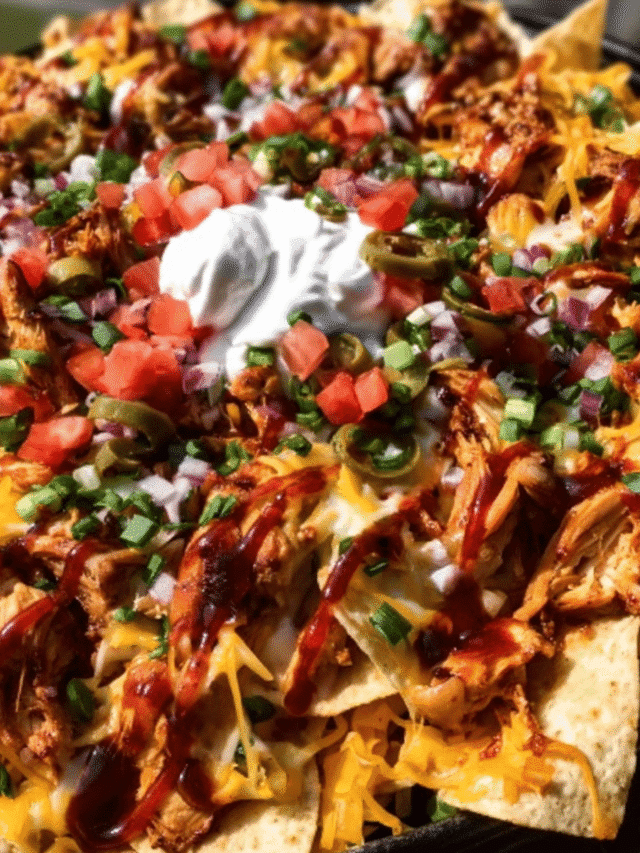 Smoky honey chicken nachos topped with melted cheddar and shredded chicken.