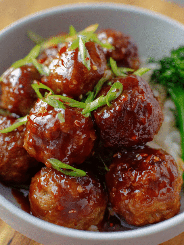 Honey garlic meatballs coated in a glossy sweet–savory sauce in a skillet