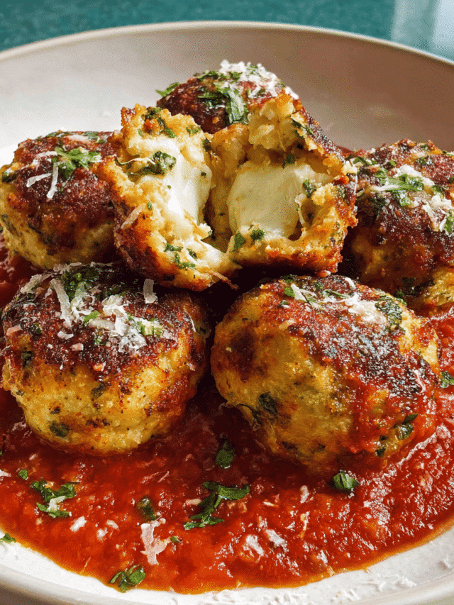 Mozzarella stuffed meatballs baked in marinara with melted cheese inside