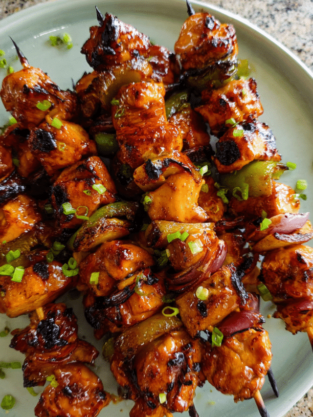 Sticky Honey Soy Chicken Skewers on a grill with glossy glaze
