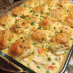 Chicken and biscuits casserole fresh out of the oven in a white baking dish