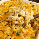 Baked cheesy chicken macaroni casserole in dish with golden topping