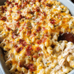 Chicken Bacon Mac and Cheese Casserole in a golden bubbly baking dish