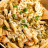 Creamy Chicken Philly Pasta Bake in a skillet with melted provolone