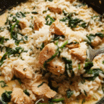 Creamy garlic chicken rice skillet in a cast iron pan