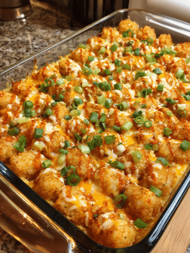 Buffalo chicken ranch casserole with crispy tater tots and melted cheese in a baking dish