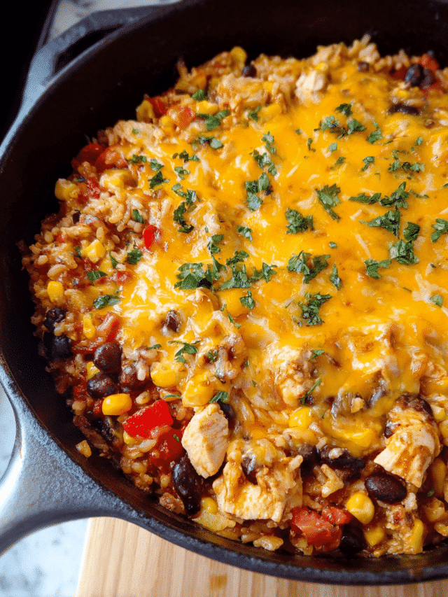 Cheesy Chicken Taco Skillet with rice, beans, and melted cheese in a skillet