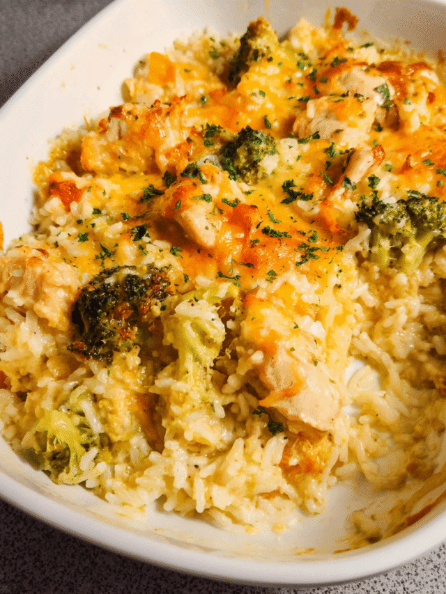 Cheesy chicken and rice casserole in white baking dish, golden melted cheese on top