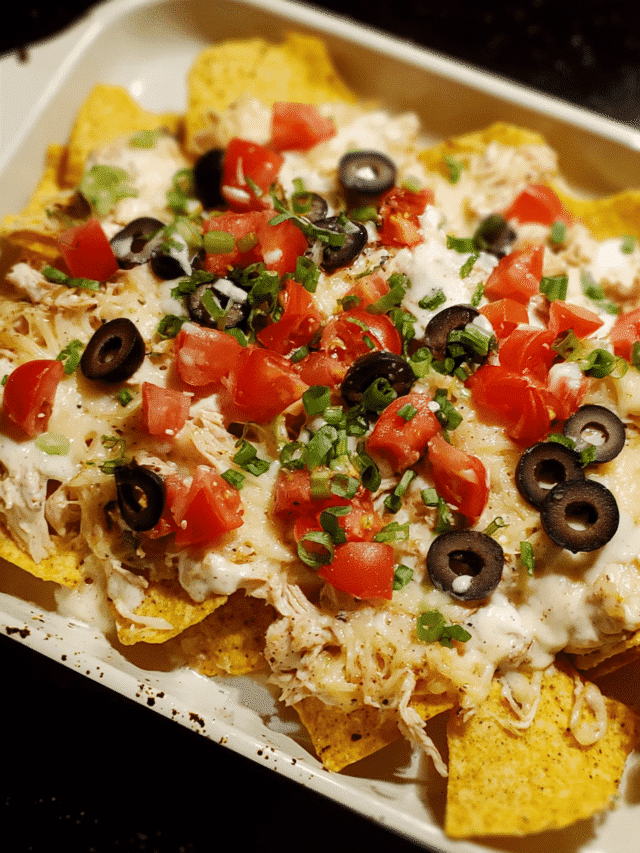 Chicken Alfredo Nacho Bake served hot with melted cheese and toppings