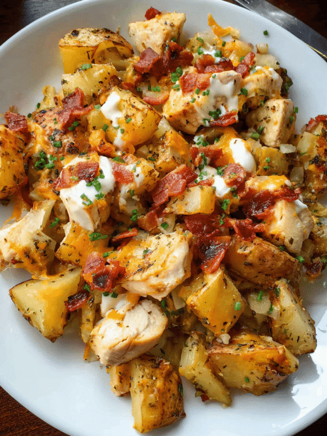 Chicken Bacon Ranch Roasted Potato Bake in casserole dish with melted cheese and bacon on top