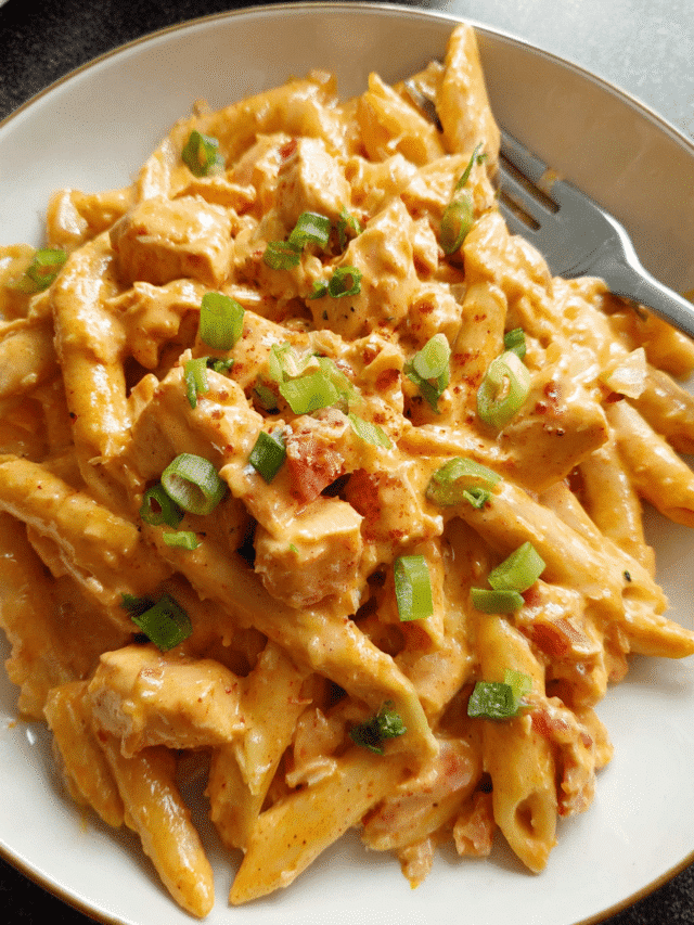 Creamy Buffalo Chicken Pasta in skillet with melted cheese and green onions