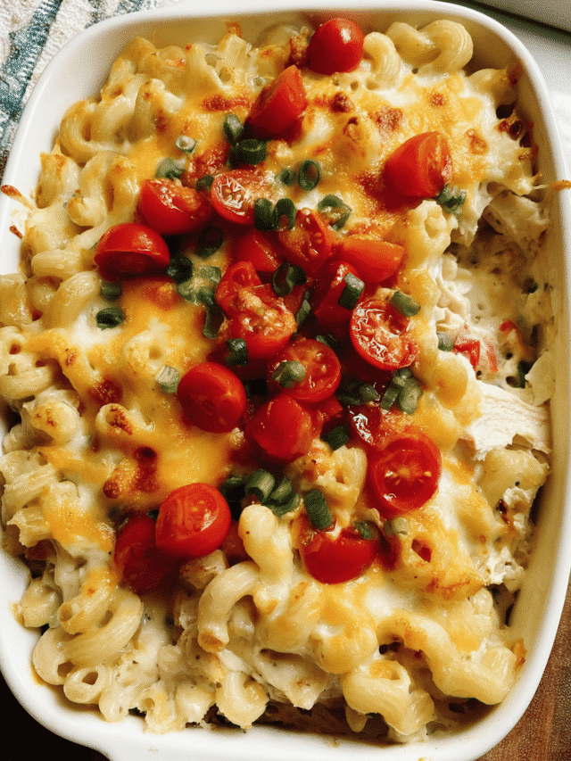 Creamy Chicken Enchilada Pasta Bake in a casserole dish with melted cheese and fresh toppings