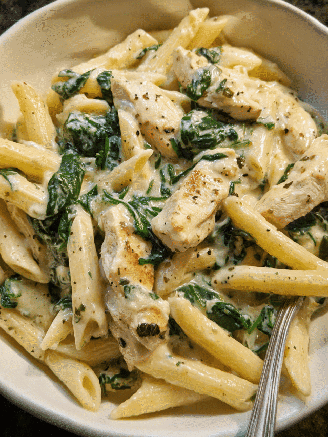 Creamy garlic chicken and spinach pasta served in a skillet