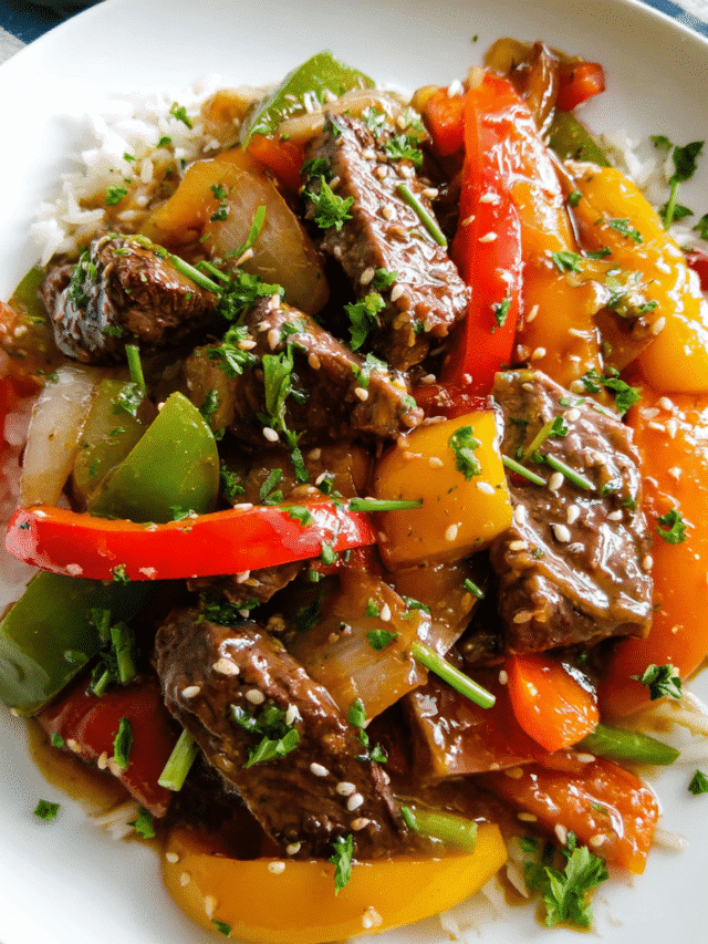 Pepper steak stir fry with colorful bell peppers in a skillet