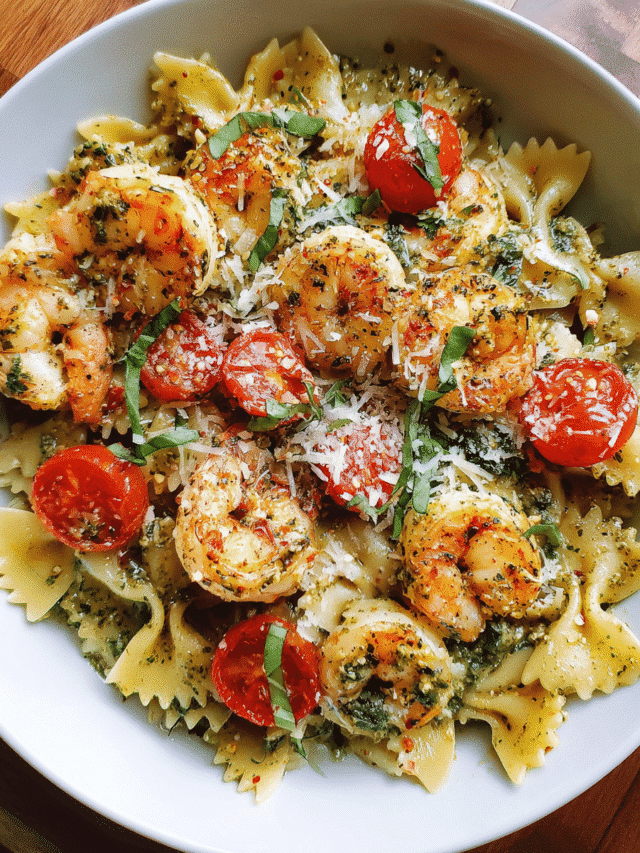 Quick Creamy Pesto Shrimp Pasta in white bowl with basil garnish