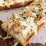 Alfredo chicken pizza toasts baked on French bread with melted mozzarella