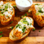 Buffalo Chicken Crostini topped with melted mozzarella and ranch drizzle