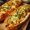 Buffalo chicken stuffed garlic bread sliced with melted cheddar and jalapeños