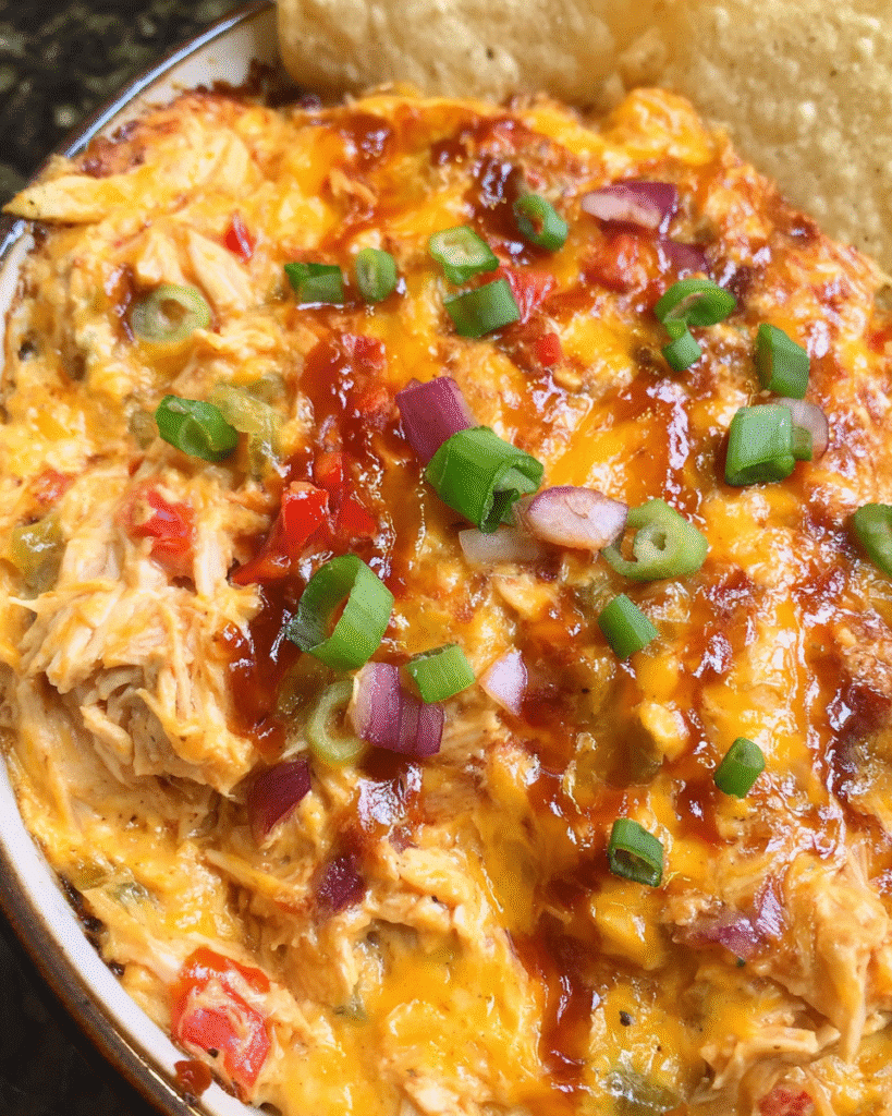 Cheesy BBQ Chicken Dip baked with melted cheddar and barbecue sauce