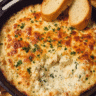 Baked cheesy chicken Alfredo dip topped with golden melted mozzarella