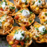 Golden cheesy chicken enchilada cups baked in a muffin tin