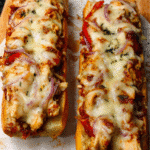 Cheesy chicken garlic bread baked with melted mozzarella and peppers