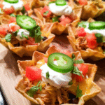 Cheesy Chicken Nacho Cups baked in muffin pan with fresh toppings