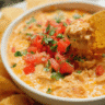 Creamy chicken nacho dip served warm with tortilla chips