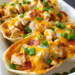 Chicken Ranch Nacho Boats topped with melted cheddar and green onions