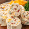 Creamy chicken ranch tortilla rolls sliced into pinwheels on a serving platter