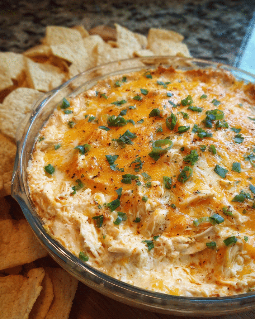 Baked chicken taco queso dip served hot with tortilla chips