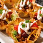 Golden baked taco cups with melted cheese and fresh toppings