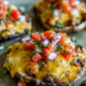 Taco Stuffed Mushrooms baked with cheddar and pico de gallo