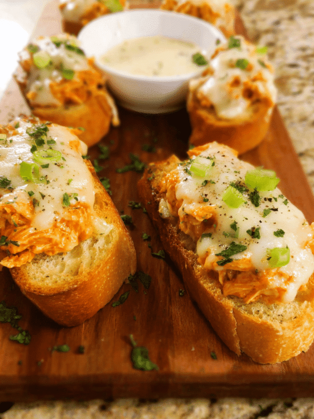 Buffalo Chicken Crostini topped with melted mozzarella and ranch drizzle