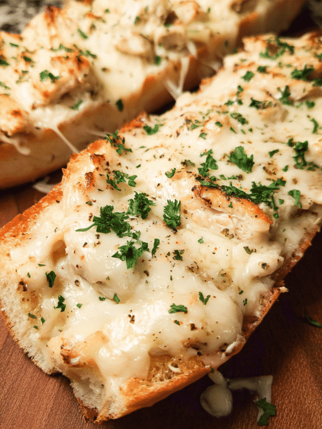 Chicken Alfredo French Bread Pizza sliced with melted mozzarella and parsley garnish