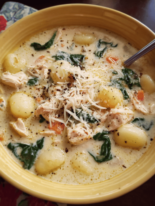 Bowl of creamy Chicken Alfredo Gnocchi Soup with spinach and Parmesan on top