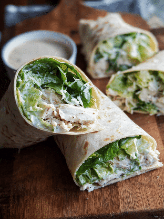 Chicken Caesar Wrap sliced in half with romaine and Parmesan