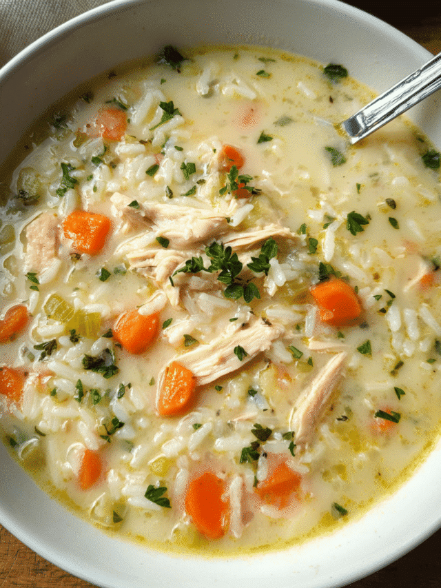Bowl of Chicken Parmesan Rice Soup with shredded chicken and herbs